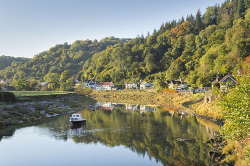 A small boat on the River Wye at Tintern. Poster Print by Loop Images Ltd. (18 x 12)