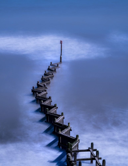 The sea surges around a breakwater. Poster Print by Loop Images Ltd. (13 x 17)