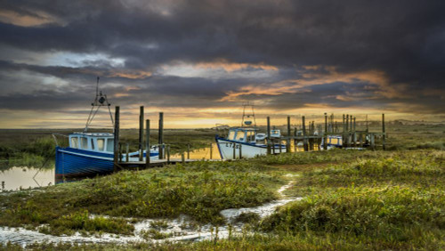 Boats at Thornham creek in Norfolk. Poster Print by Loop Images Ltd. (19 x 10)