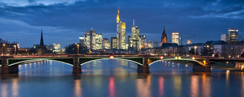 The River Main Ignatz Bubis Bridge and skyscrapers of Frankfurts business district at night. Poster Print by Loop Images Ltd. (22 x 8)