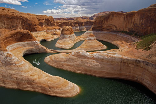 Boat traces the curves of Reflection Canyon, part of Glen Canyon National Recreation Area in Utah, USA; Utah, United States of America Poster Print by Michael Melford (17 x 11)