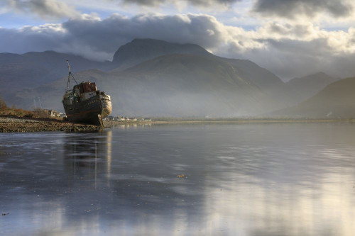 An abandoned boat with Ben Nevis in the distance. Poster Print by Loop Images Ltd. (20 x 13)
