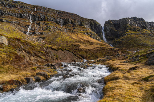 Numerous waterfalls flow down the mountains of South Iceland as winter gives way to spring; Iceland Poster Print by Robert Postma (19 x 12)