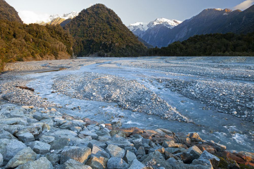 Meltwater from the Franz Josef Glacier flows into the Tasman Sea in New Zealand. Poster Print by Loop Images Ltd. (18 x 12)