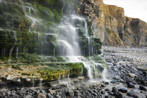 Cliff Waterfall on Dunraven Bay. Poster Print by Loop Images Ltd. (18 x 12)