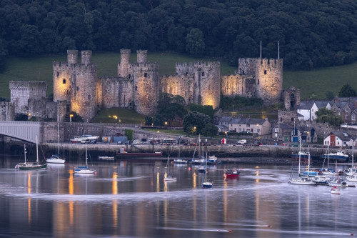 Conwy Castle at dusk across the Conwy Estuary in North Wales. Poster Print by Loop Images Ltd. (20 x 13)
