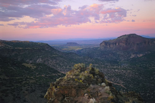 Gorges and rock formations on a vast desert landscape at sunset; New Mexico, United States of America Poster Print by Joel Sartore Photography (17 x 11)