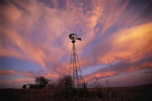 Silhouette of a tall wind vane in a glowing sunset sky; Dunbar, Nebraska, United States of America Poster Print by Joel Sartore Photography (17 x 11)