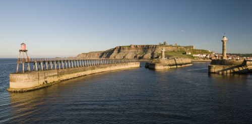 View of Whitby Pier looking back towards the town with the Abbey on the hill in the background. Poster Print by Loop Images Ltd. (20 x 10)