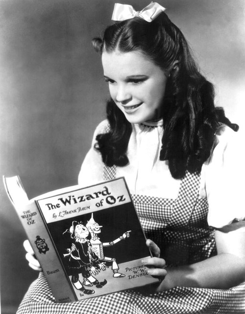 Judy Garland, Dressed As Dorothy Reading The Wizard Of Oz Poster Print