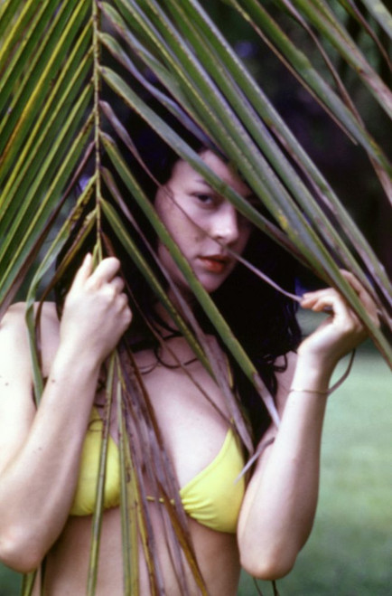 Meg Tilly on the set of the 1988 movie Girl in a Swing, wearing a yellow bikini. Photo: Oscar Abolafia (megtilly006) Poster