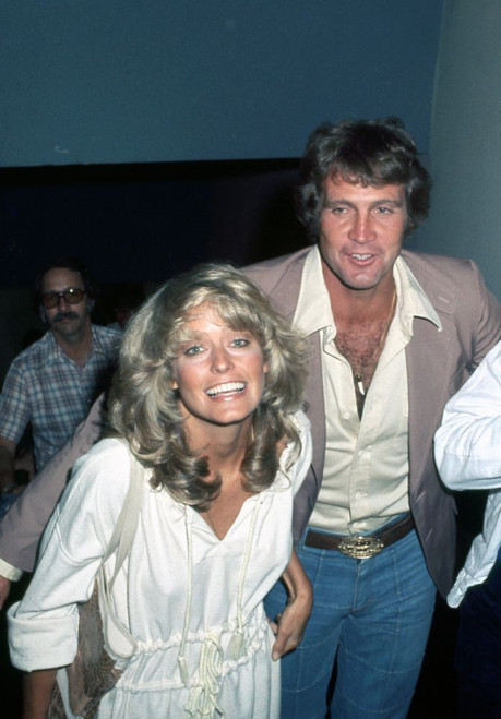 Farrah Fawcett and Lee Majors, smiling, at New York event, 1970s. Photo: Oscar Abolafia (farrahfawcett_leemajors001) Poster