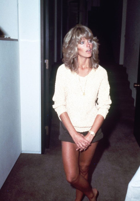 Farrah Fawcett wearing a sweater and shorts, 1970s. Photo: Oscar Abolafia (farrahfawcett044) Poster