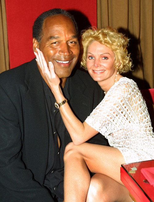 EXCLUSIVE. Miami Beach, FL 2-7-02. OJ Simpson and friend Tammy Wu enjoy a night out at KISS Restaurant. Photo by Adam Scull (OJ_Tammy_5518) Poster