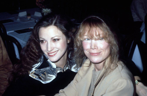 Actresses Jane Seymour and Sissy Spacek smiling, sitting together at event, 1980s. Photo: Oscar Abolafia (janeseymour_sissyspacek001) Poster