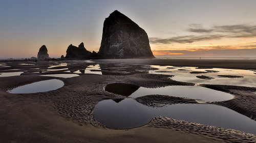 USA- Oregon. Cannon Beach with Haystack near sunset and low tide. Poster Print - Darrell Gulin