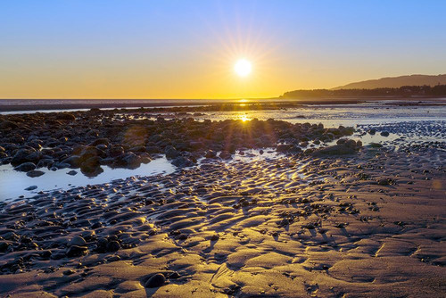 Alaska- Homer Spit. A sunset landscape over tide pools. Poster Print - Janet Muir