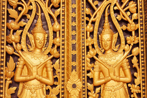 Laos- Luang Prabang. Golden relief carvings. Poster Print - Tom Haseltine