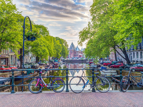 Bicycles parked along the canal, Amsterdam Poster Print - Assaf Frank