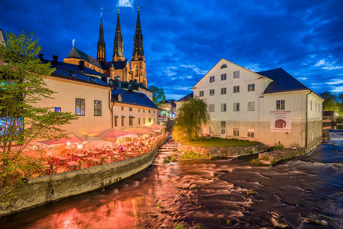 Sweden-Central Sweden-Uppsala-Domkyrka Cathedral with riverfront cafe-dusk Poster Print - Walter Bibikow # VARPDXEU28WBI0601