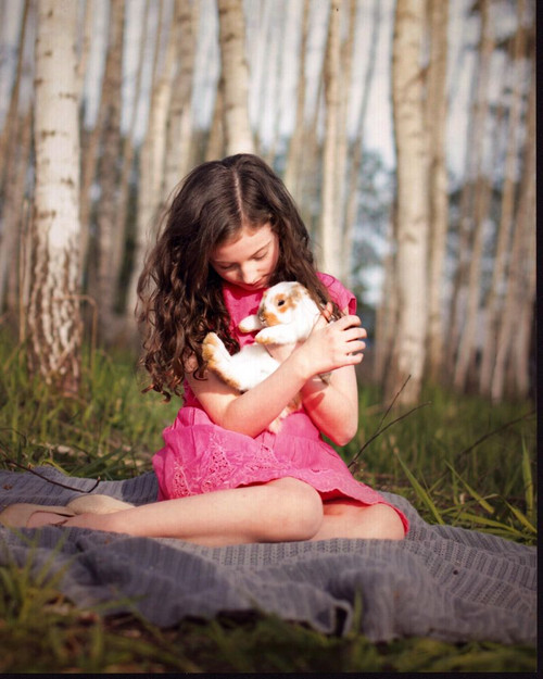 Allison James In Pink Dress Holding Rabbit Photo Print - Item # MVM58490
