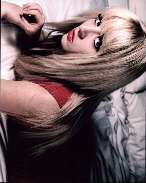 Delfina Alden Laying On Bed In Red Top Photo Print - Item # MVM55526