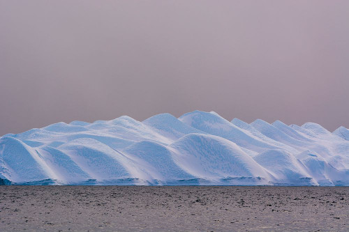 An iceberg in Ilulissat Icefjord-a UNESCO Site-on a cloudy day Ilulissat-Greenland Poster Print - Sergio Pitamitz