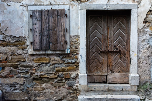A view of a wooden door and shuttered window Isola-Slovenia Poster Print - Sergio Pitamitz