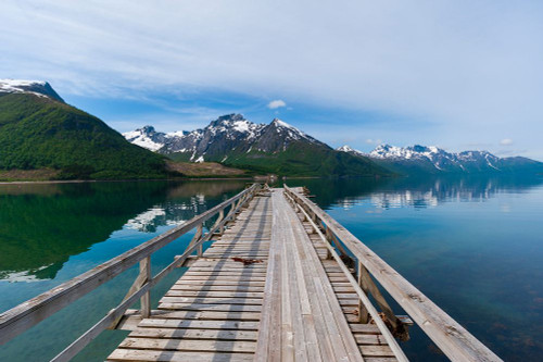A pier on Holandsfjorden-rimmed with ice streaked mountains-near Svartisen Svartisen-Norway Poster Print - Sergio Pitamitz