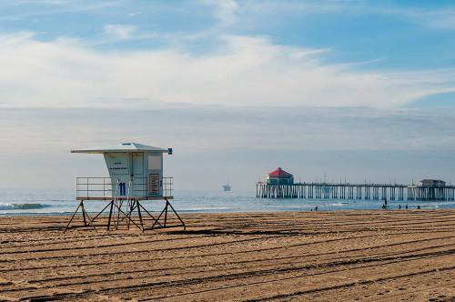 Lifeguard shack and pier on almost deserted Huntington Beach-on the Pacific Ocean-California Poster Print - Sergio Pitamitz