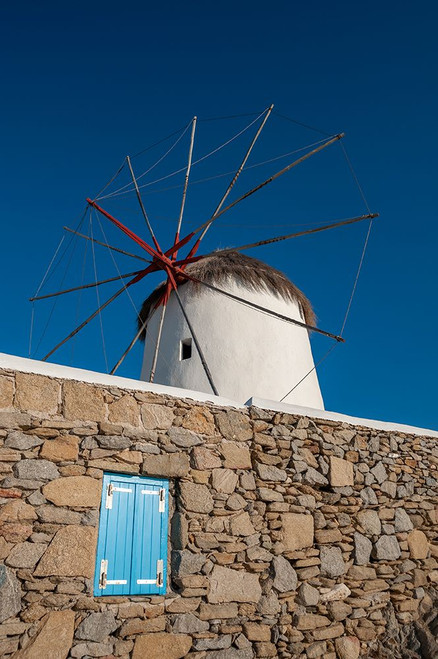 A traditional windmill set behind a rock masonry wall Chora-Mykonos Island-Greece Poster Print - Sergio Pitamitz