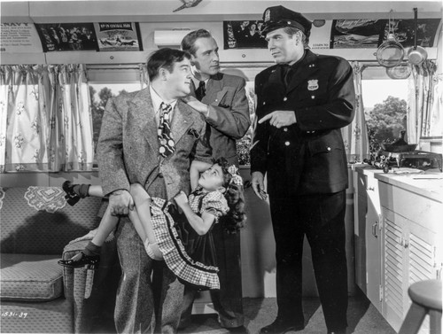 Abbott & Costello Holding a Girl while Talking to the Policeman Photo Print - Item # VARCEL680749