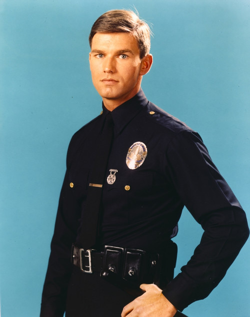 Adam-12 Man in Police Uniform Making Serious Face in Blue Background Photo Print - Item # VARCEL680770