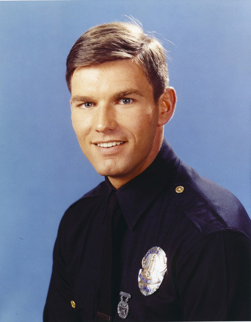 Adam-12 Posed in Police Officer Uniform with a Smile in a Portrait wish Blue Background Photo Print - Item # VARCEL680771