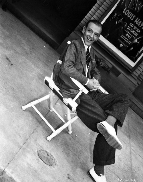 Fred Astaire Seated on Chair with a Smile in Black and White Photo Print - Item # VARCEL681034