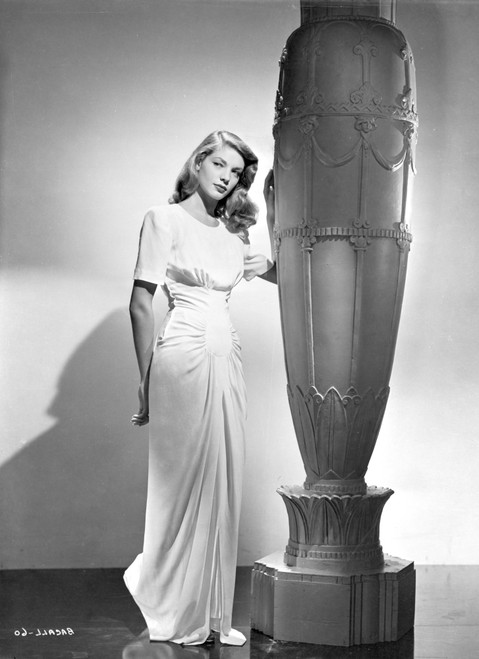 Lauren Bacall wearing a dress by a sculpture Photo Print - Item # VARCEL681232
