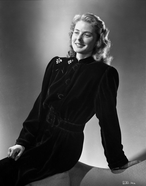 Ingrid Bergman sitting on a Couch in a Long Sleeve Dress with Brooch Photo Print - Item # VARCEL681982