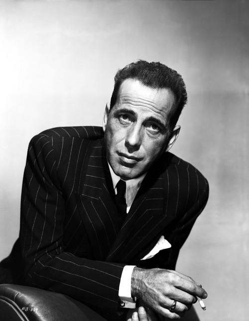 Humphrey Bogart in a suit and tie cuffs showing with a cigarette Portrait Photo Print - Item # VARCEL682293