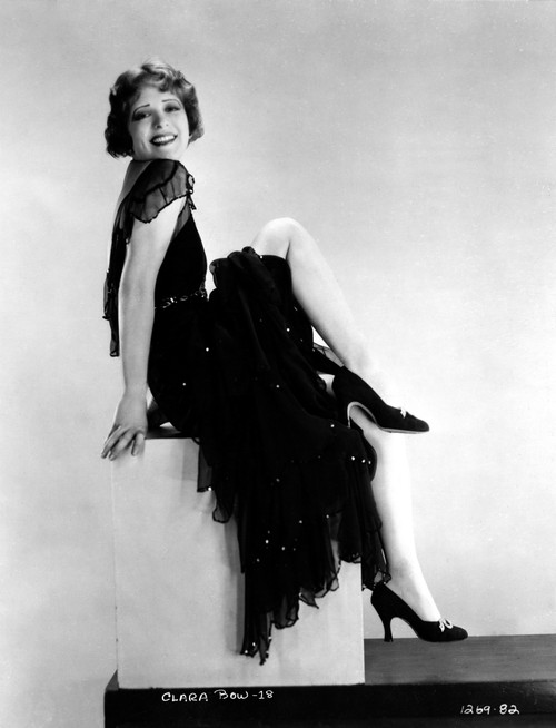 Clara Bow sitting on Stair, wearing Black Dress with One Leg Raise Photo Print - Item # VARCEL682422