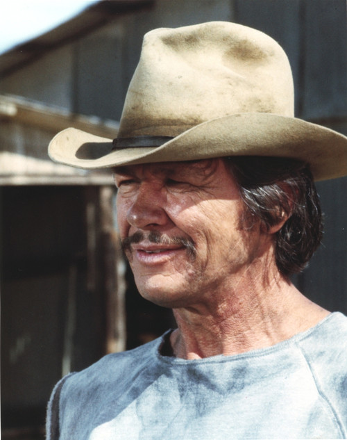 Charles Bronson smiling in Blue Shirt and Brown Hat Photo Print - Item # VARCEL682775