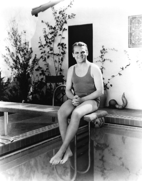 James Cagney wearing a bathing suit sitting on a diving board Photo Print - Item # VARCEL683261