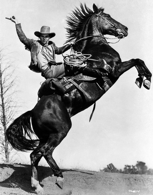 James Cagney Rode on a Black Horse in Long Sleeve Coat and Cowboy Hat with Right Hands Raise Up Photo Print - Item # VARCEL683282