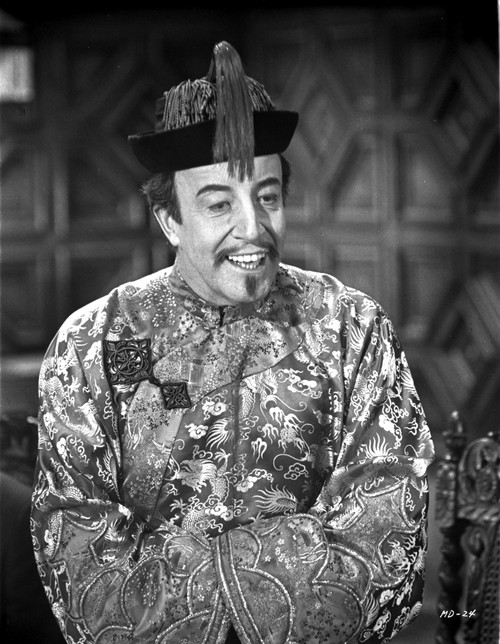A film still of Peter Sellers wearing a Chinese costume Photo Print - Item # VARCEL683726