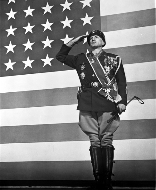 George C Scott saluting in front of an American flag Photo Print - Item # VARCEL683739