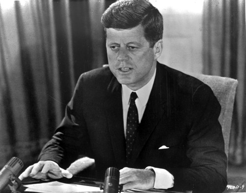 President John F Kennedy sitting at a desk Photo Print - Item # VARCEL683746