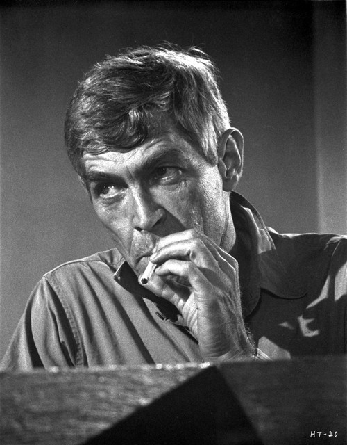 Film still of James Coburn smoking a cigarette Photo Print - Item # VARCEL683987