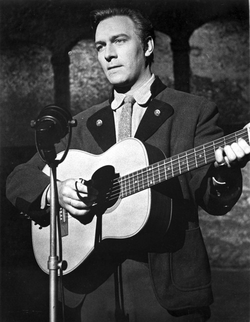 Christopher Plummer playing a guitar on stage Photo Print - Item # VARCEL684057