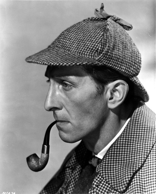 Peter Cushing wearing a detectives costume and smoking a pipe Photo Print - Item # VARCEL684157
