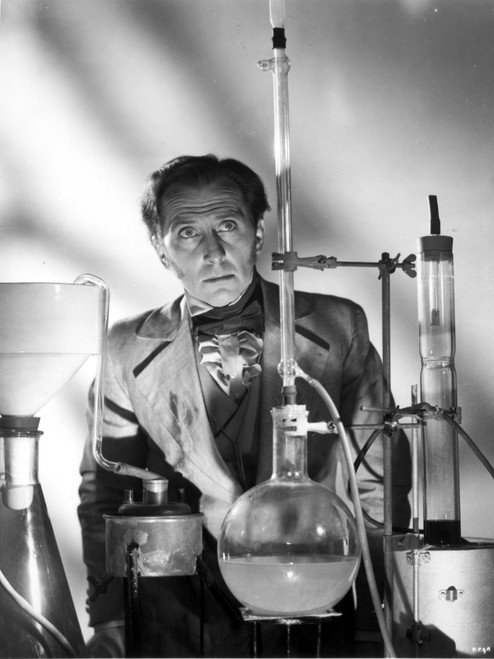 Peter Cushing with chemistry equipment Photo Print - Item # VARCEL684159