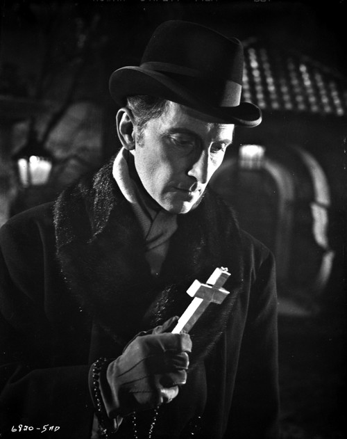 Film still of Peter Cushing holding a cross Photo Print - Item # VARCEL684164